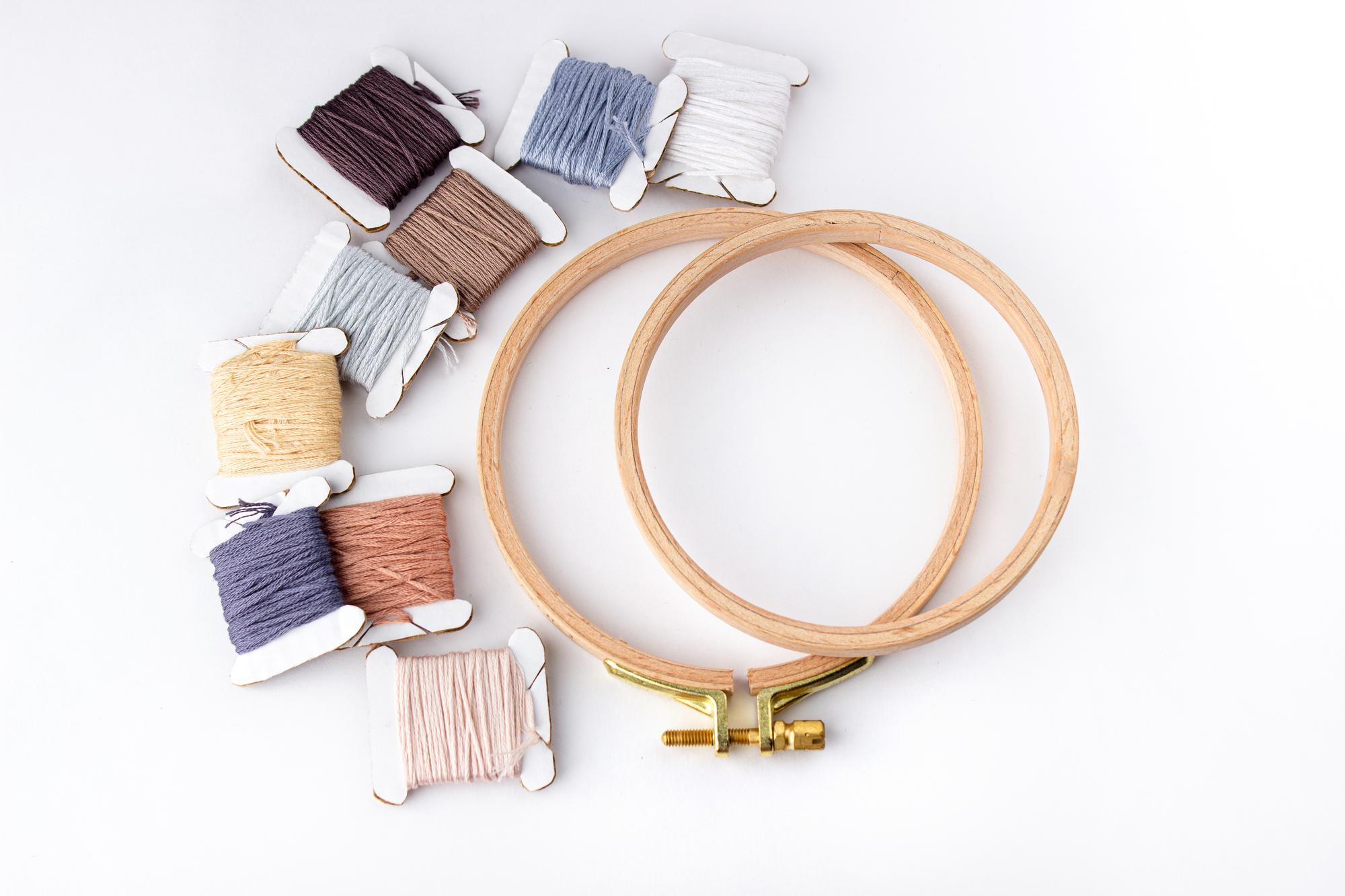 Student stitching on hoop in studio